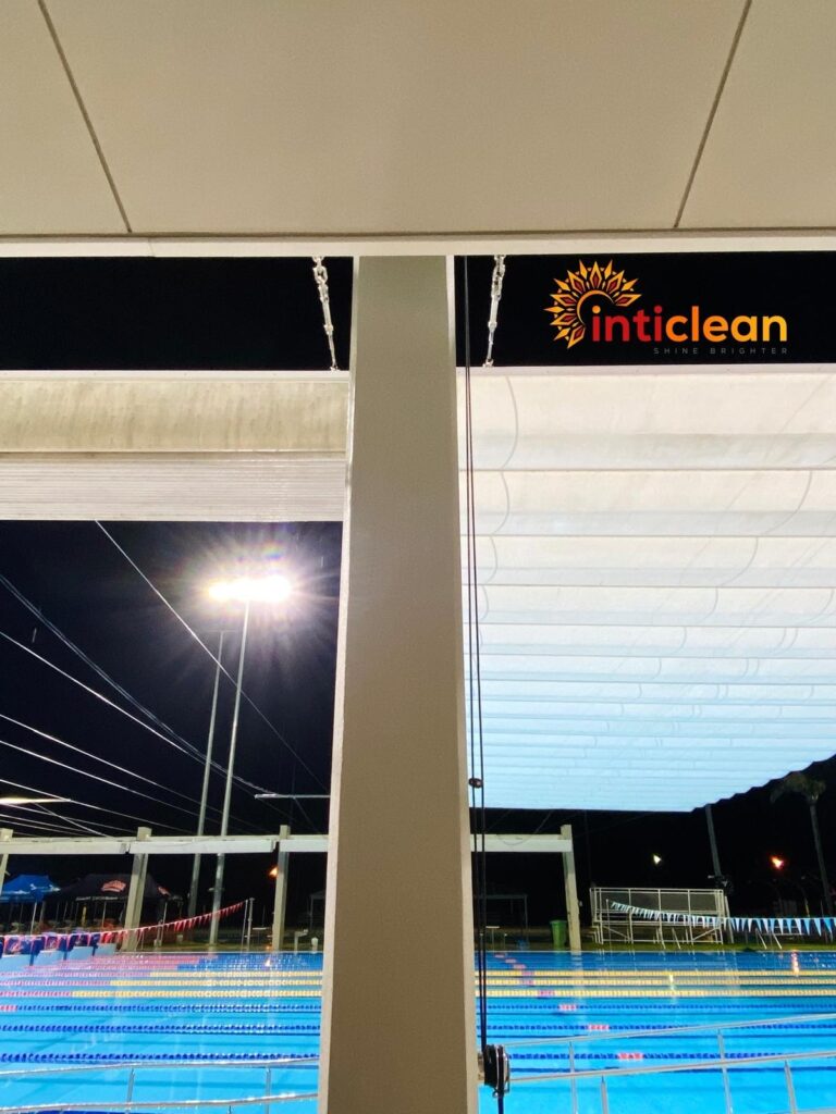 Inticlean commercial cleaning at outdoor swimming pool shade structure with night lighting